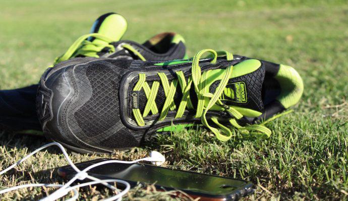 Brooks Ghost 9 GTX® Shoes pictured in grass next to iPhone and headphones