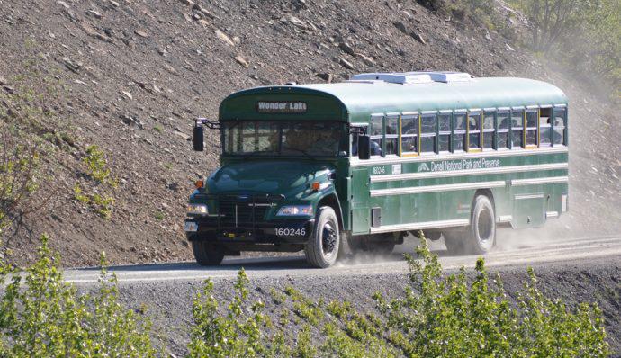 A bus riding down the road in Denali National Park