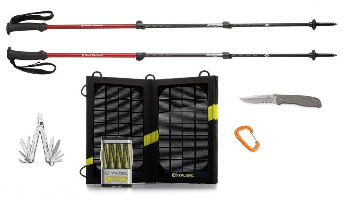 An image of a solar panel charger, Black Diamond trekking poles, a multi-tool, and a folding knife
