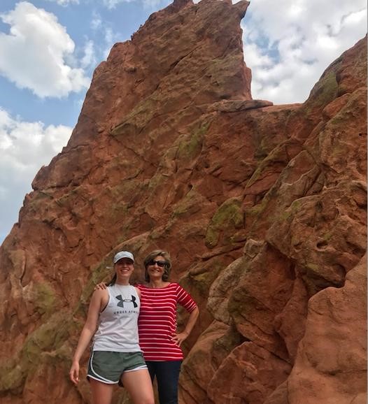 "Two women in front of red rocks"