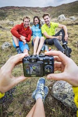 A group of friends hiking on Madeira Island stopped to make photos, sit laughing and joking