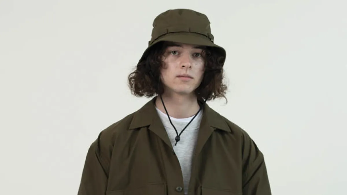 Caucasian Woman in brown trench coat and brown bucket hat