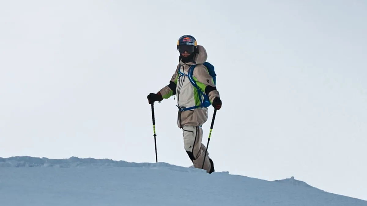 Skier standing on top of a snowy peak