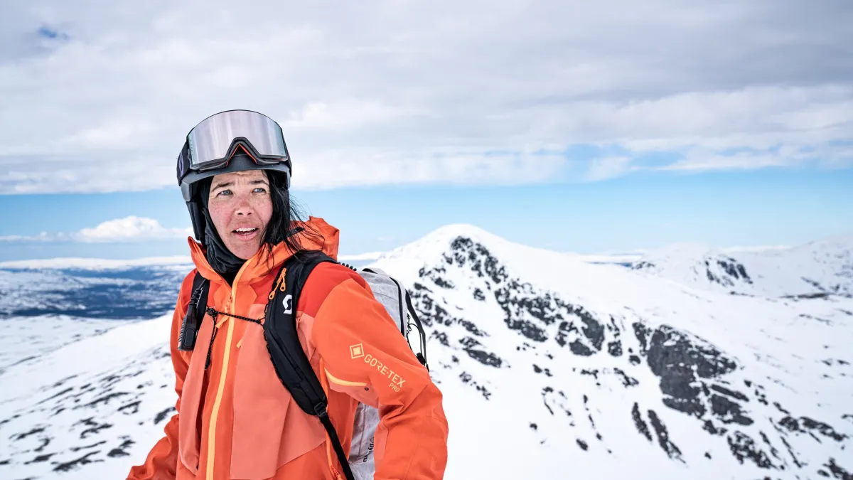 Jackie Passo on a snowy mountain, looking into the distance