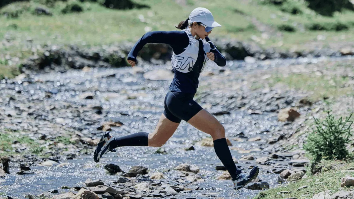 Zheng Junyue running through a creek