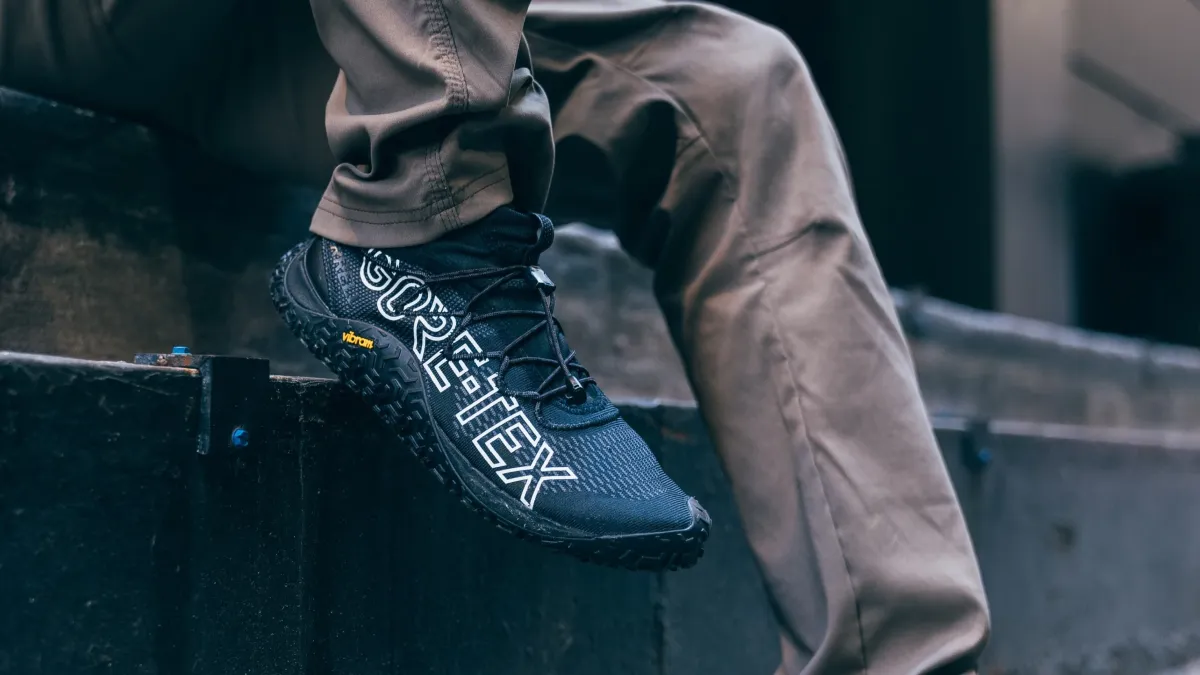 Man wearing GORE-TEX Footwear, sitting on steps