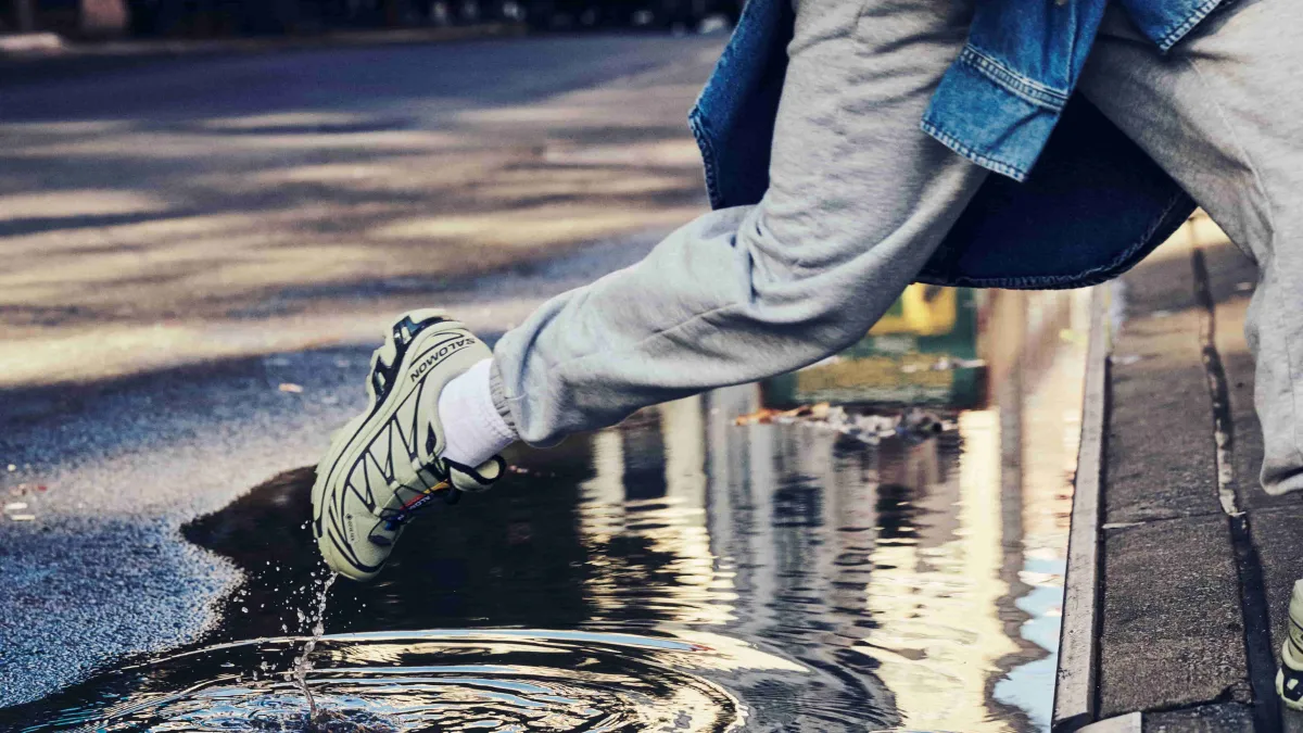 Close of Salomon GORE-TEX Shoes walking through a puddle