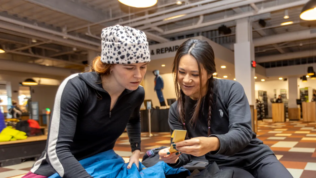 Two women discussing the GORE-TEX Outerwear rentals