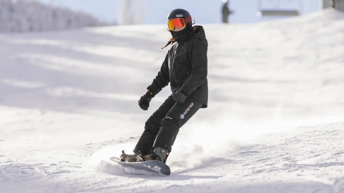 Snowboarder going down mountain