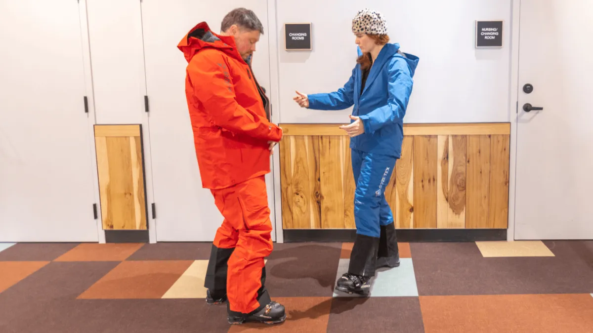 Rep helping a customer find the fit of their GORE-TEX Gear