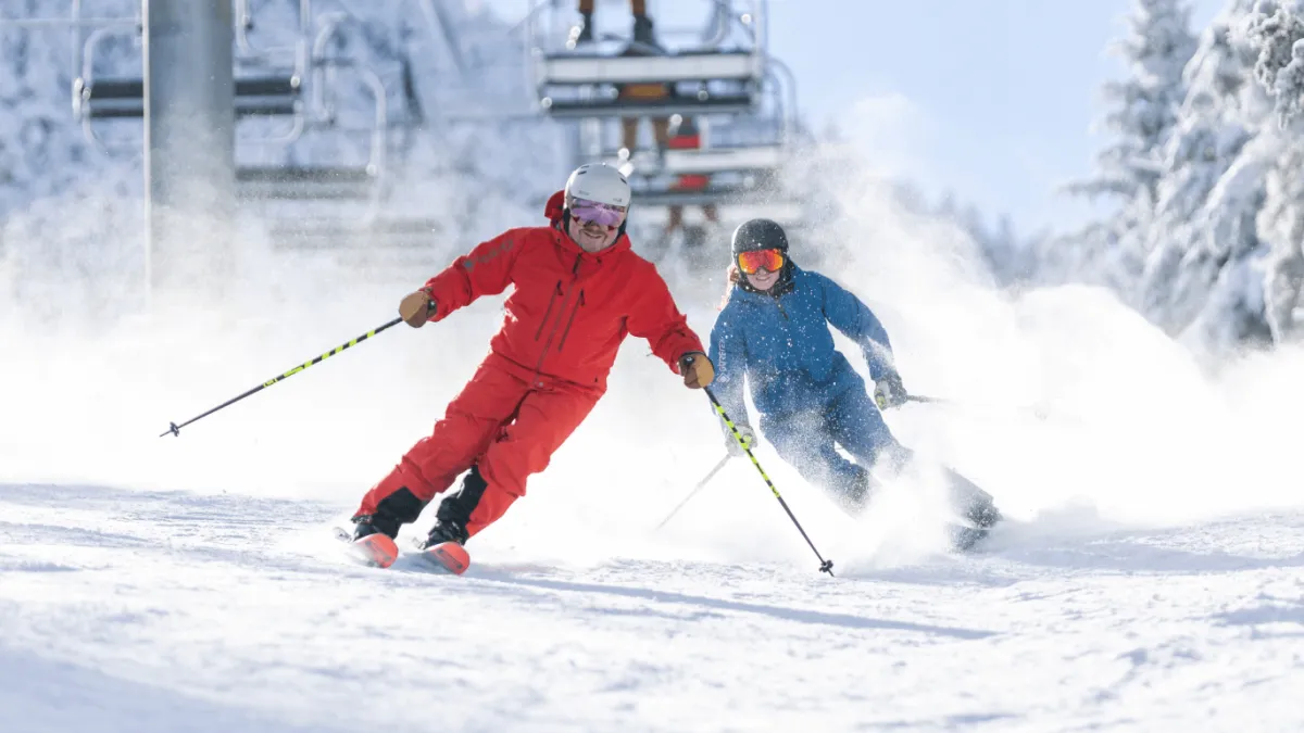 Two people skiing