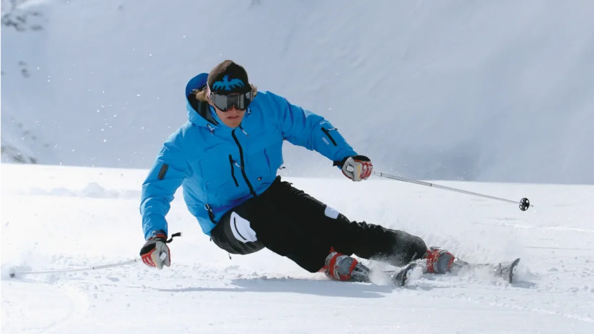 A skier carving a turn in GORE-TEX rental gear